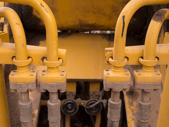 Symmetric hydraulic tubing and fittings on a CAT digger.