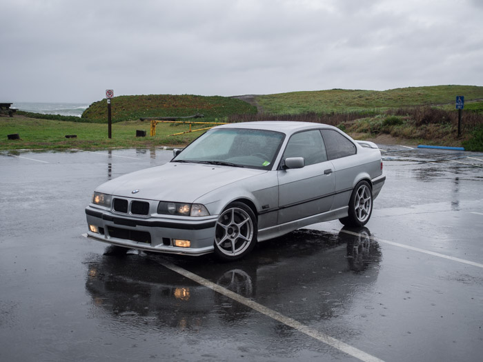 BMW E36 parked in the rain.