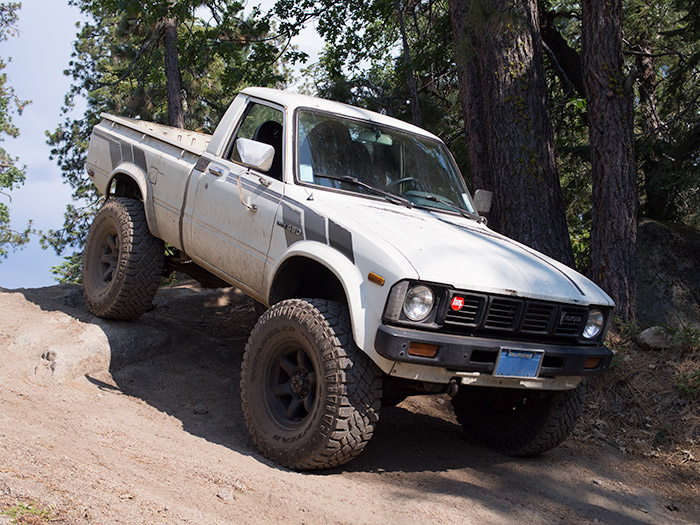 White 1981 Toyota Pickup offroading.